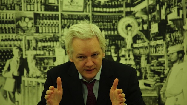 Julian Assange speaks via videolink to EU parliament on corruption